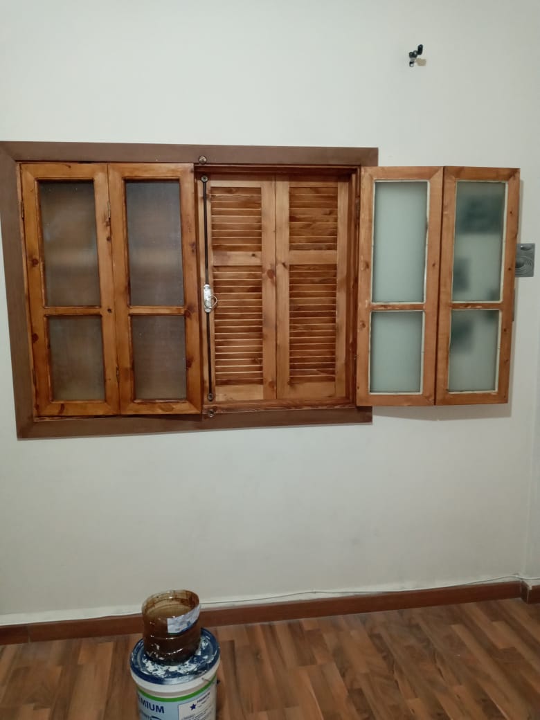 Wooden window installation with shutters